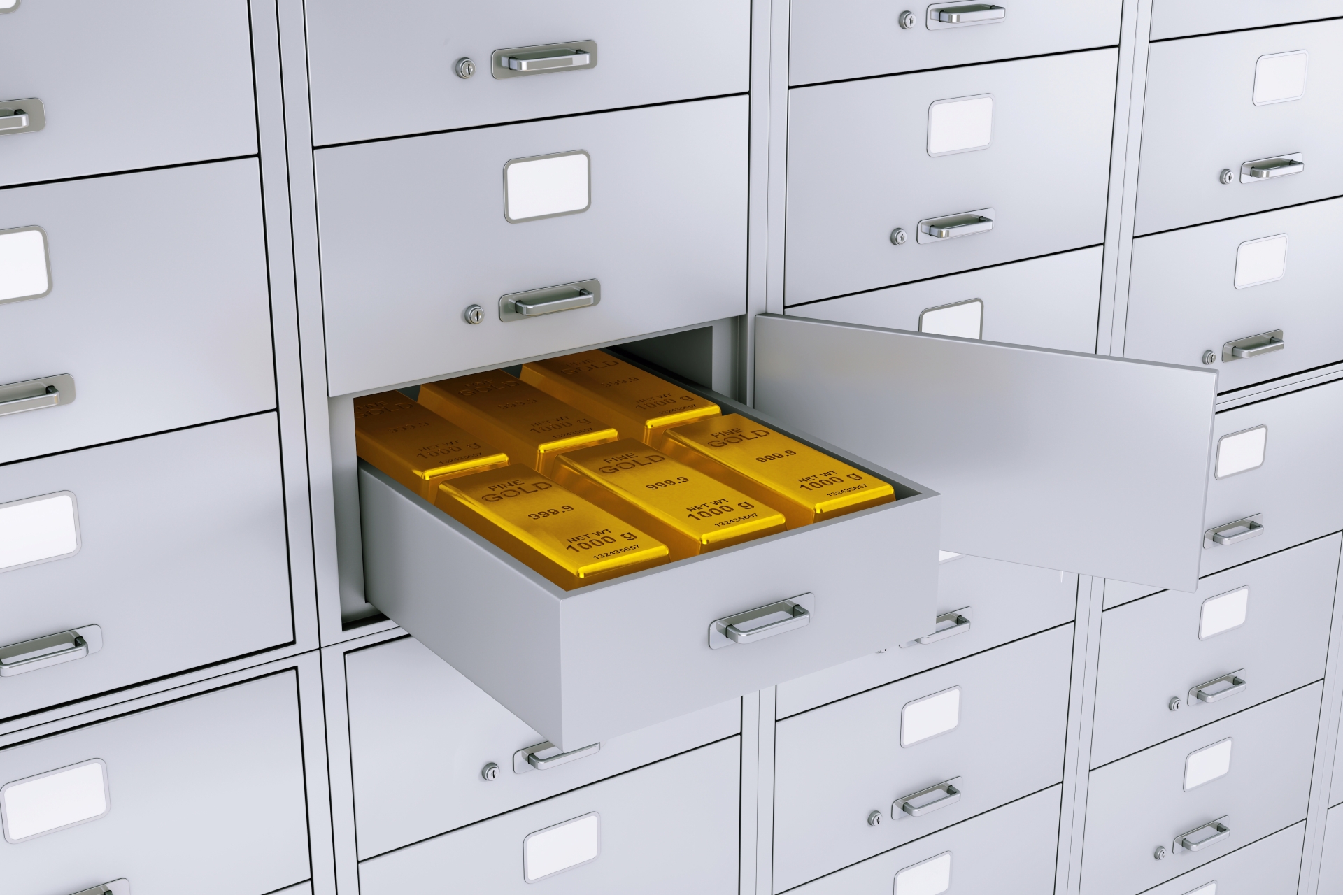 Several 1000g fine gold bullion bars stored in an open grey metal drawer within a large vault.