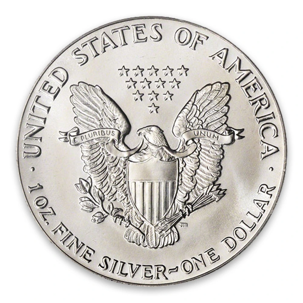 Close-up of the reverse side of a United States silver dollar coin featuring the eagle, shield, and stars with '1 OZ FINE SILVER' inscription.