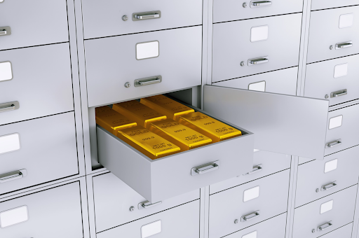 Pure gold bullion bars neatly stacked inside a modern white drawer, highlighting organized precious metal storage.