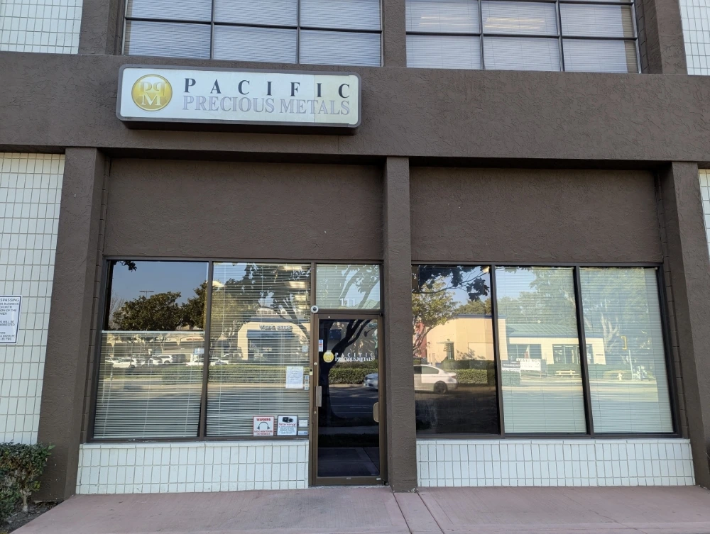 Pacific Precious Metals storefront with brown facade and gold logo sign.