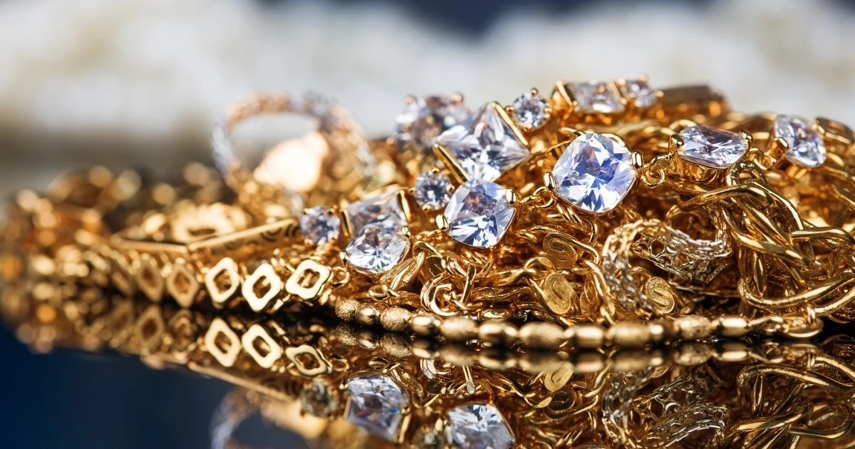 Shiny gold chains and diamond-studded jewelry reflecting investment-grade precious metals and luxury value.