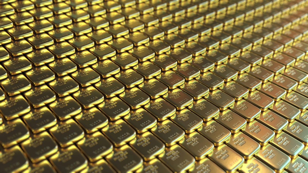 Dozens of gleaming gold bars arranged in rows, showcasing bulk investment at Pacific Precious Metals.