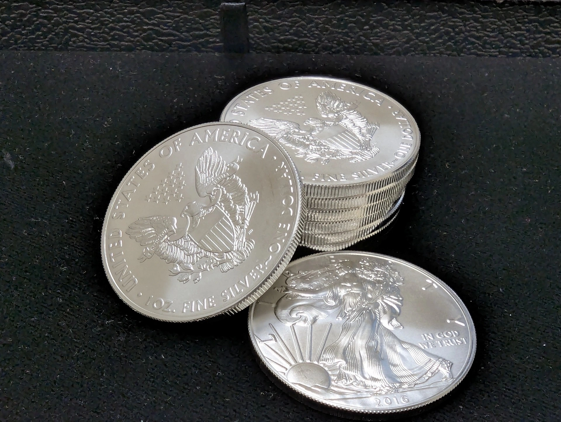 American Silver Eagle coins stacked on black cloth at Pacific Precious Metals.