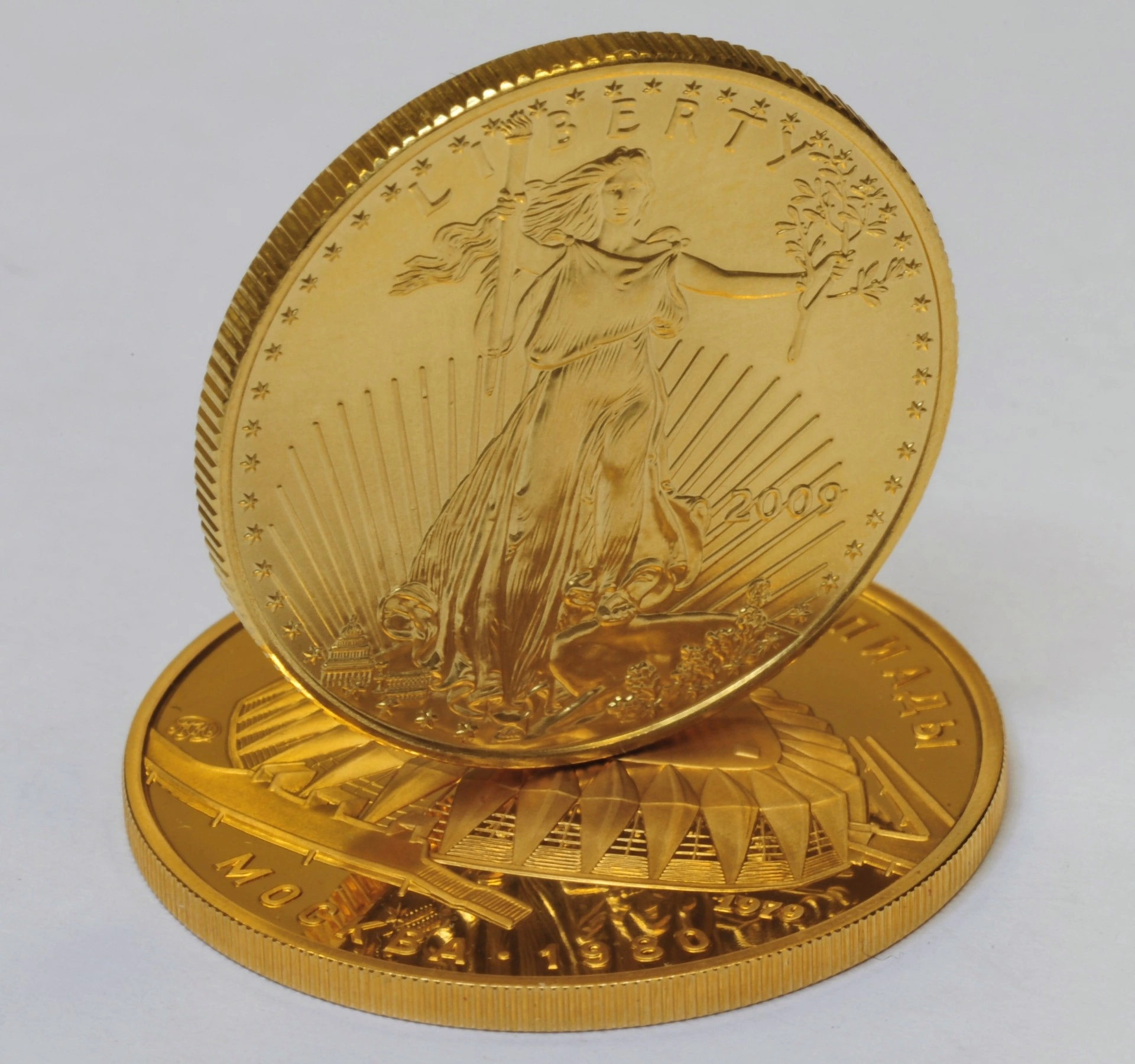 Close-up of American Gold Eagle coins showing the Liberty design and detailed gold finish.