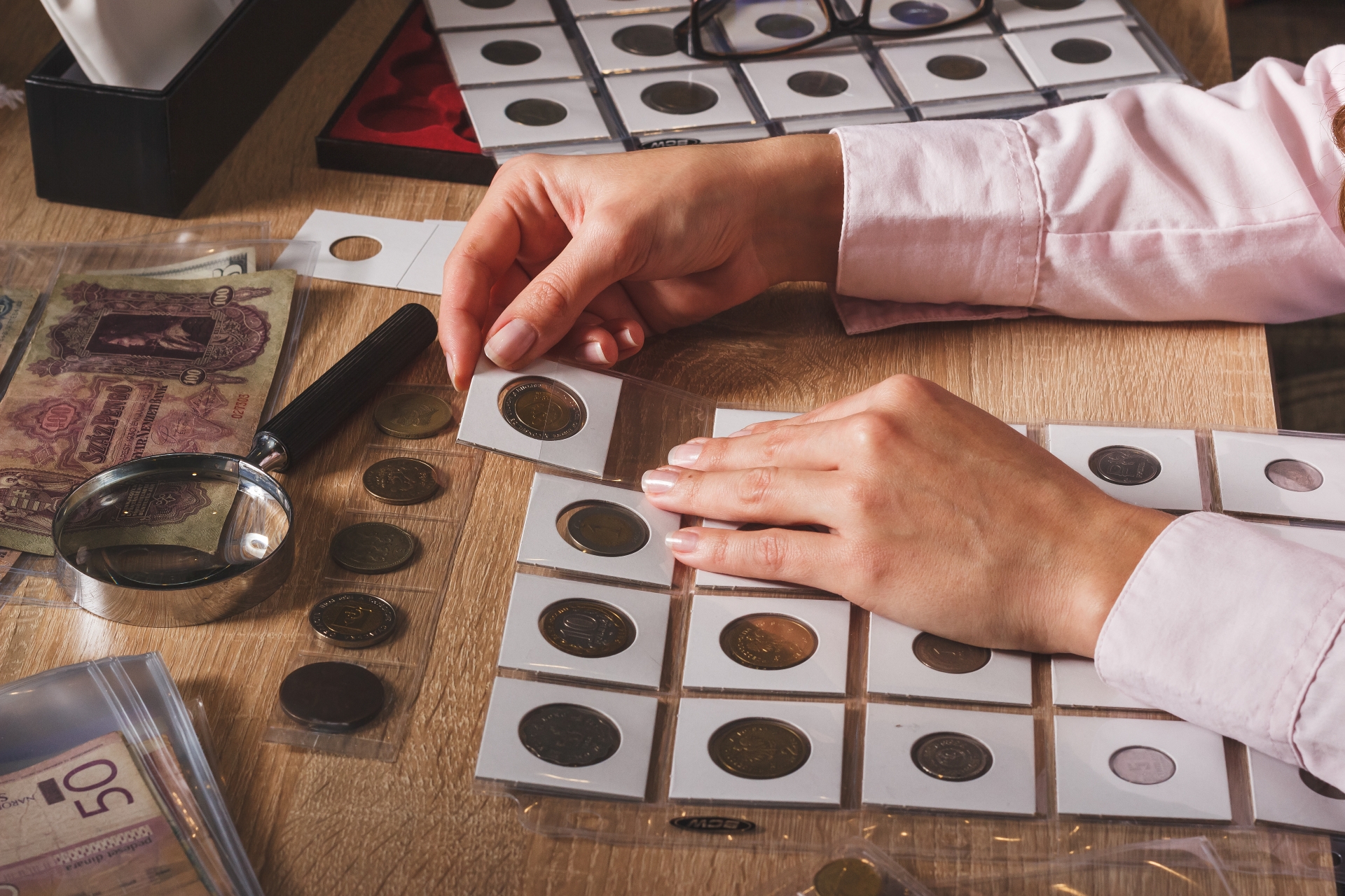 A diverse pile of silver and gold-colored international coins from various countries and denominations.